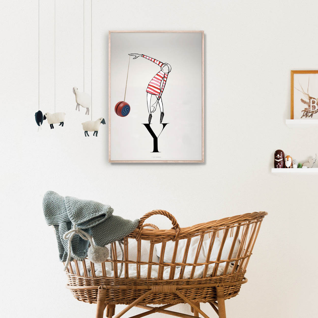 a bassinet basket with modern nursery artwork